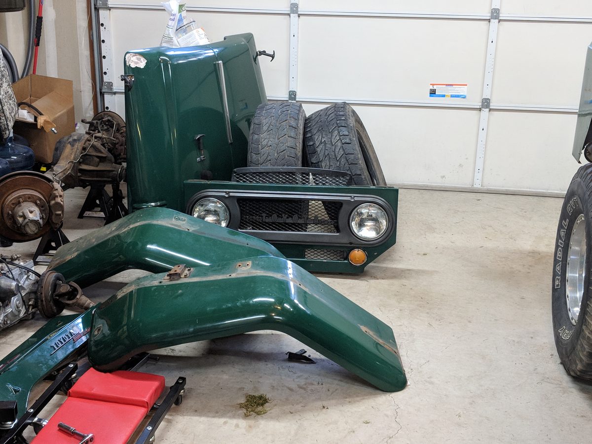 All body panels removed and laid out across the garage