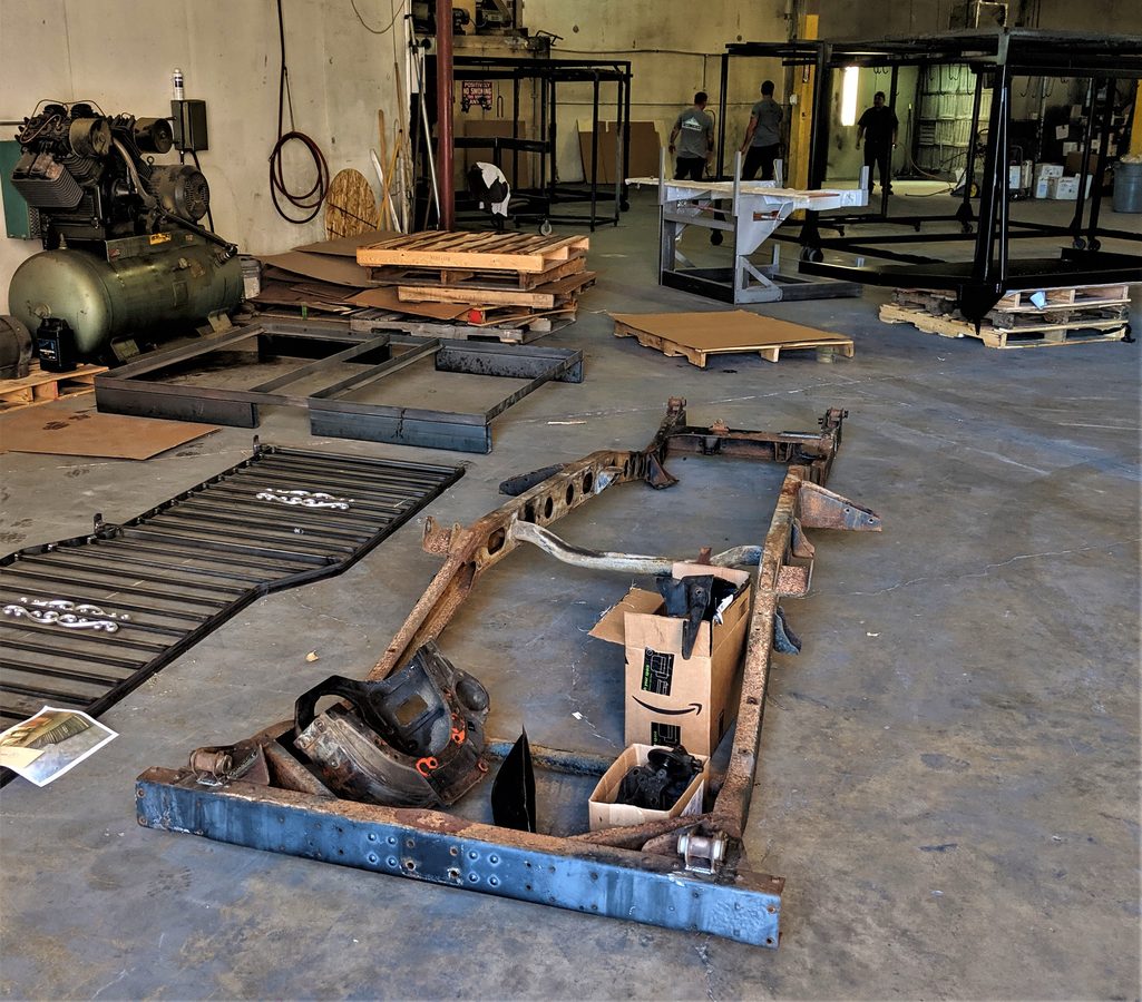 Bare original frame stripped at a fabrication shop